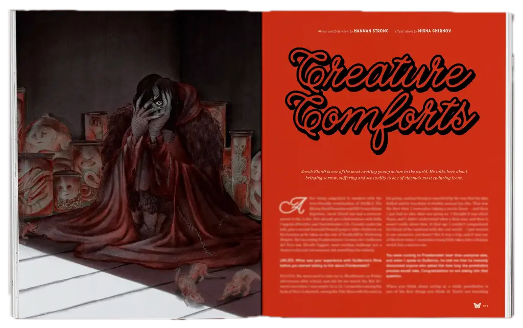 Open book spread showing dark sculptural figure draped in burgundy fabric on left page, bright red page with "Creature Comforts" text on right.